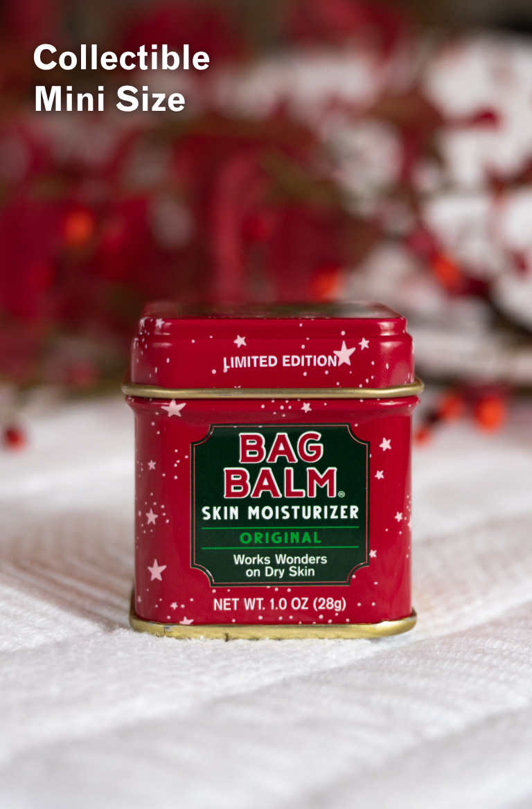 Red tin of Bag Balm on a white surface.