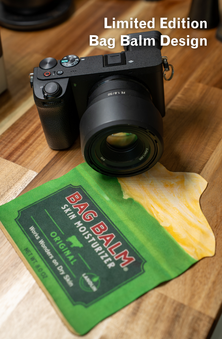 A glasses wipe shaped like a Bag Balm tin in front of a camera