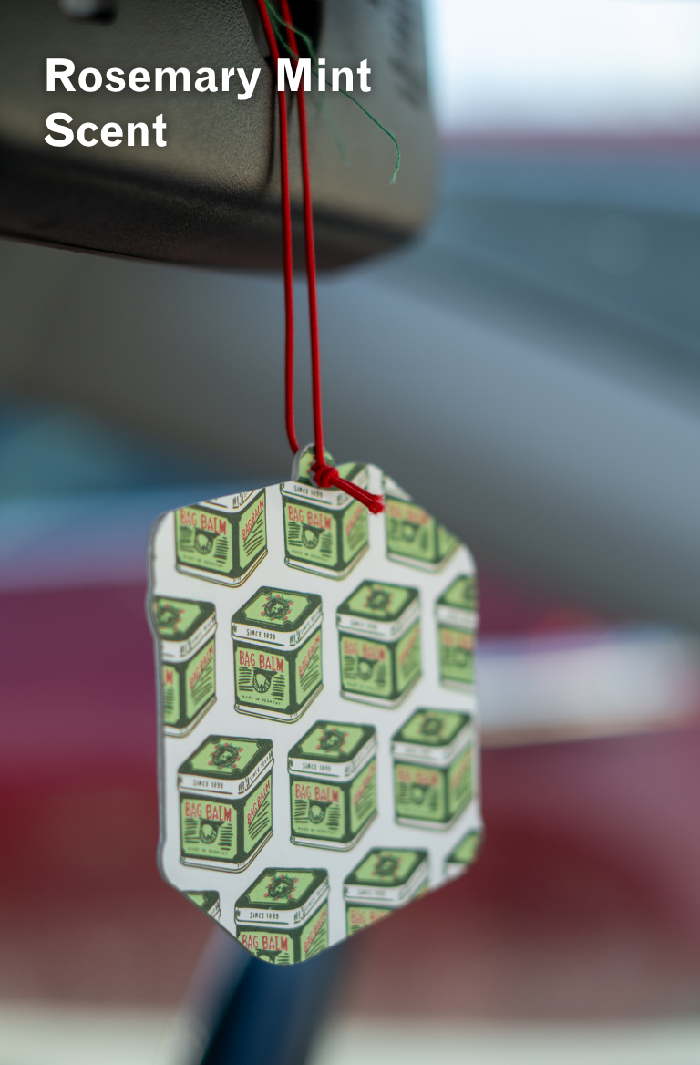 Bag Balm Air Freshener hanging from rear view mirror in car, back view