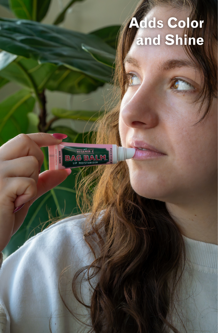 Person applying a tube of lip balm with text 'Adds Color and Shine' above.