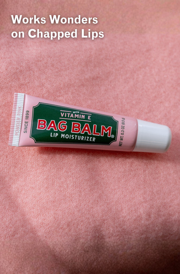 Bag Balm Powder Pink Lip Moisturizer on a pink background with text 'Works Wonders on Chapped Lips'.