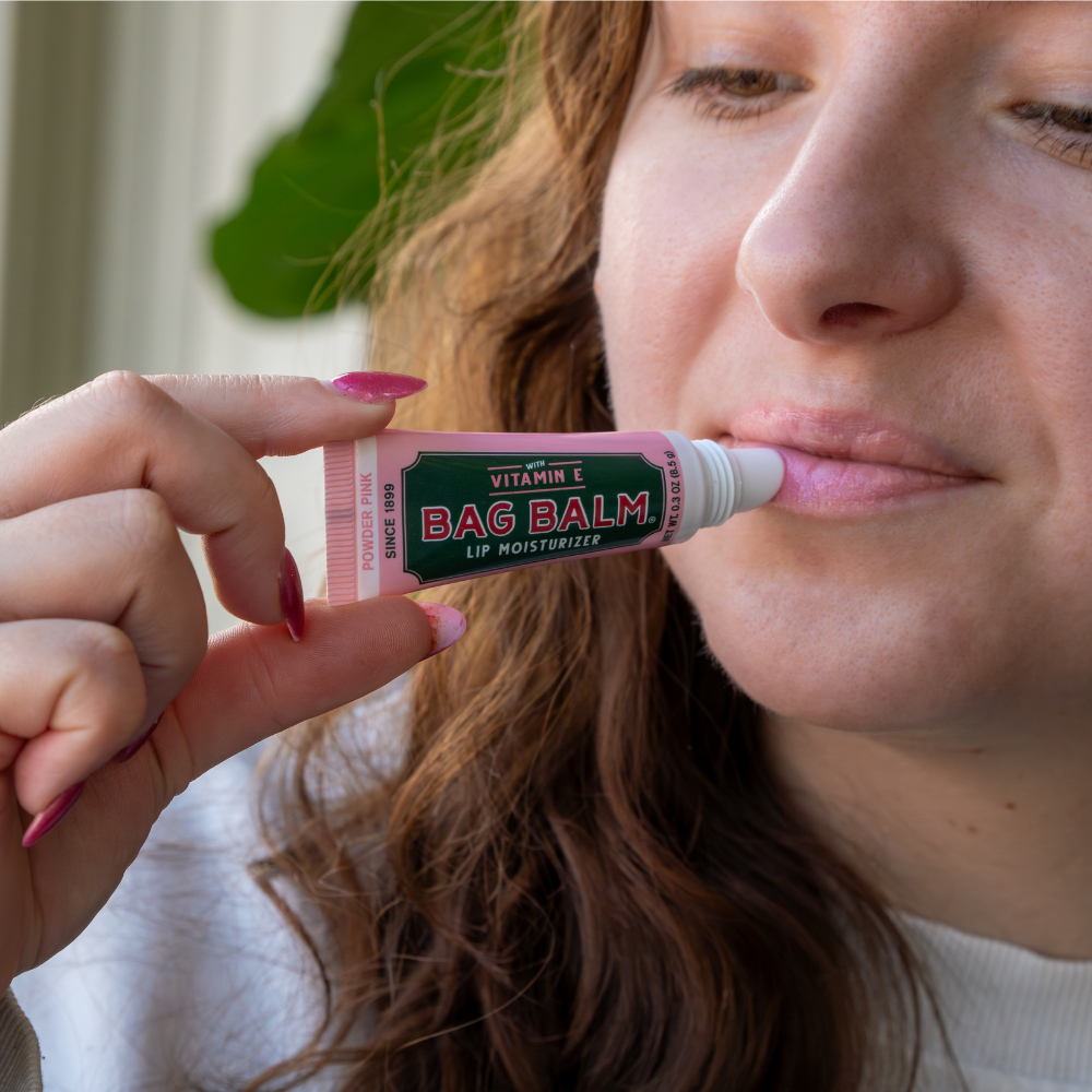 Person applying Bag Balm lip balm to their lips