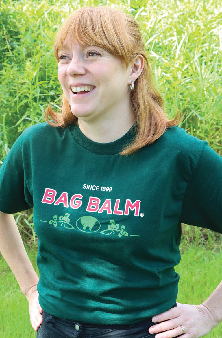 Woman Laughing in green T-shirt with Bag Balm logo