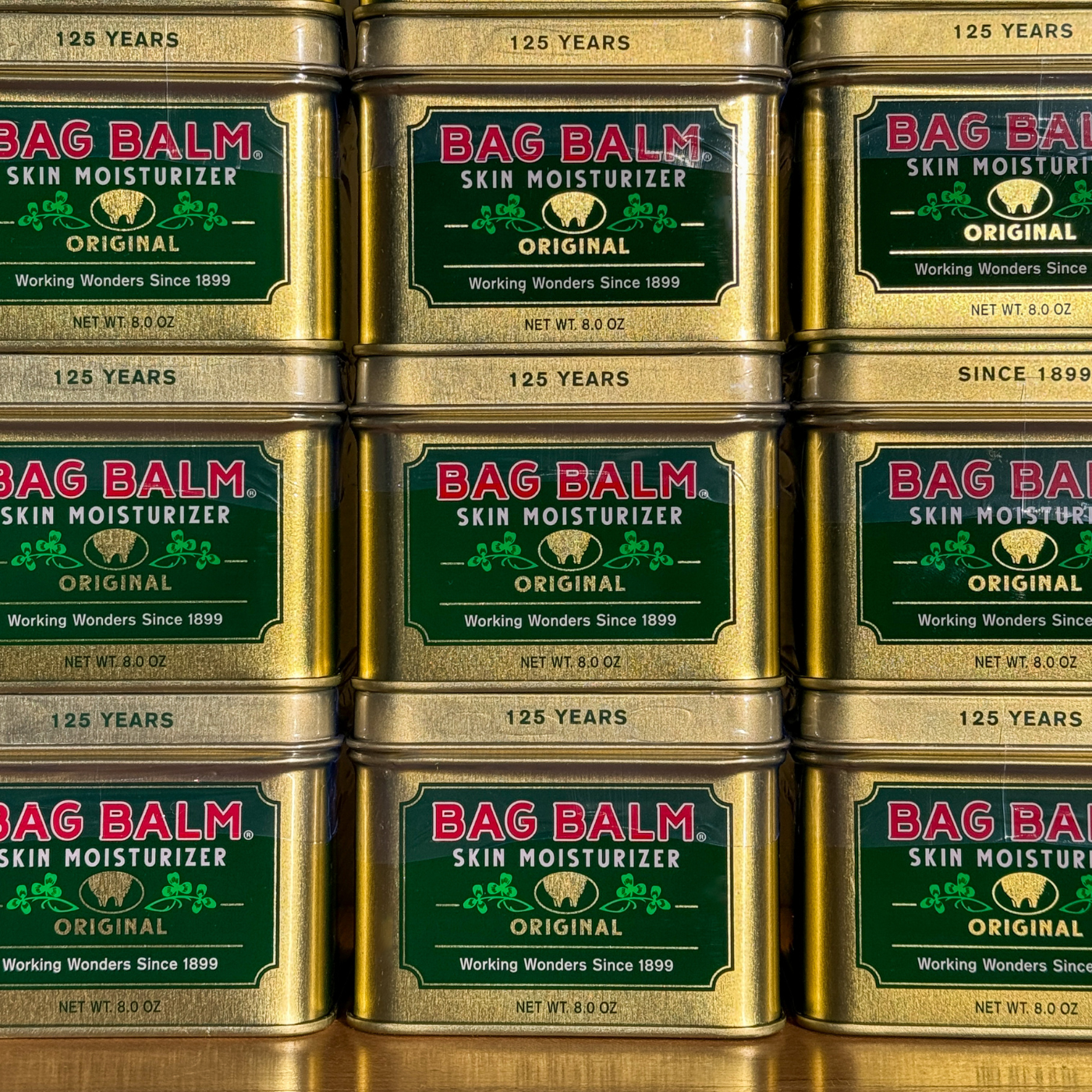 Stacked gold tins of Bag Balm
