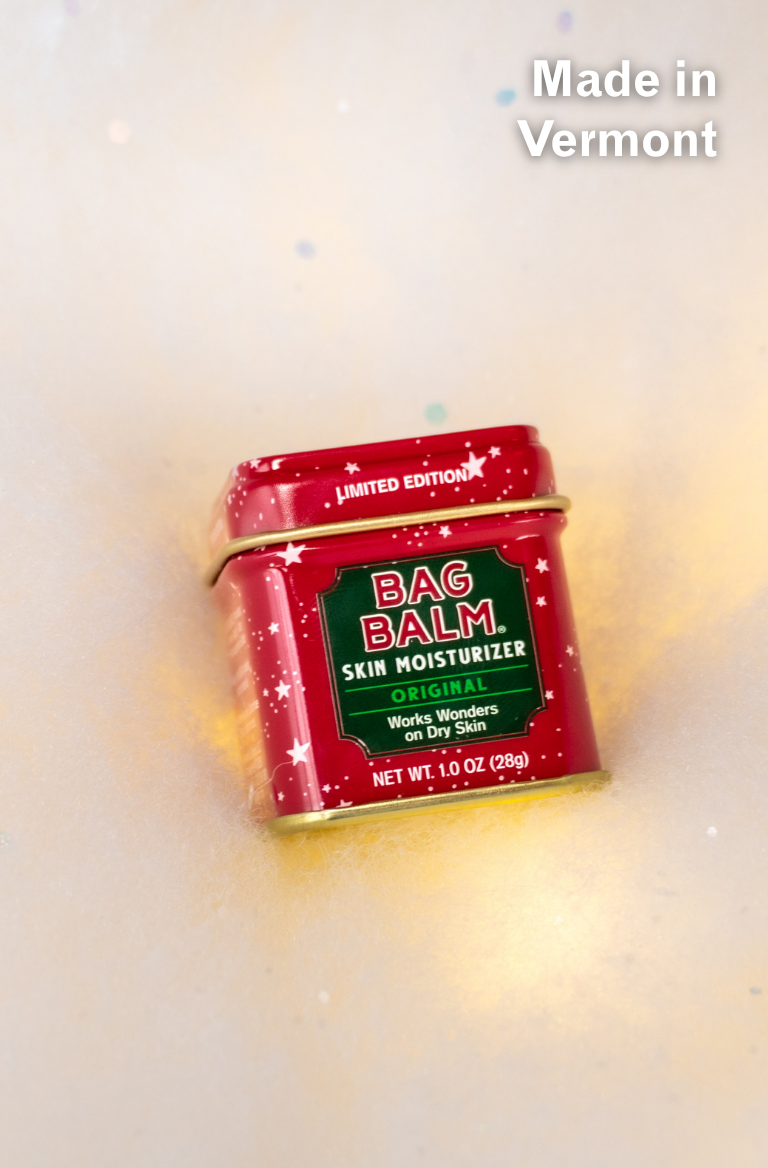 Red tin of Bag Balm on a light background