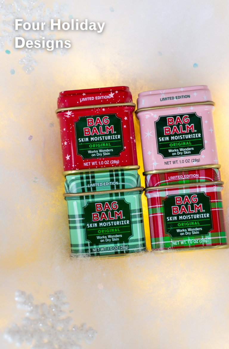 Four tins of Bag Balm skin moisturizer with festive designs on a light background.