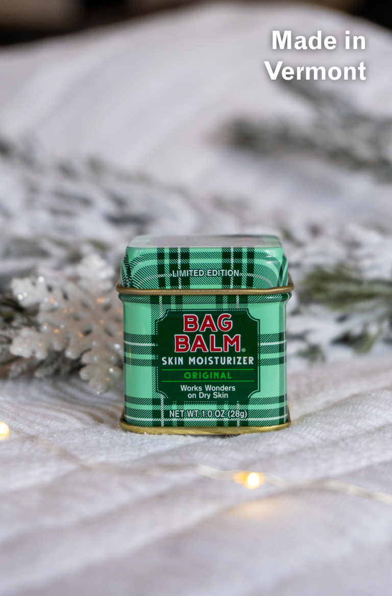 Green plaid tin of Bag Balm skin moisturizer with 'Made in Vermont' text on a white background.