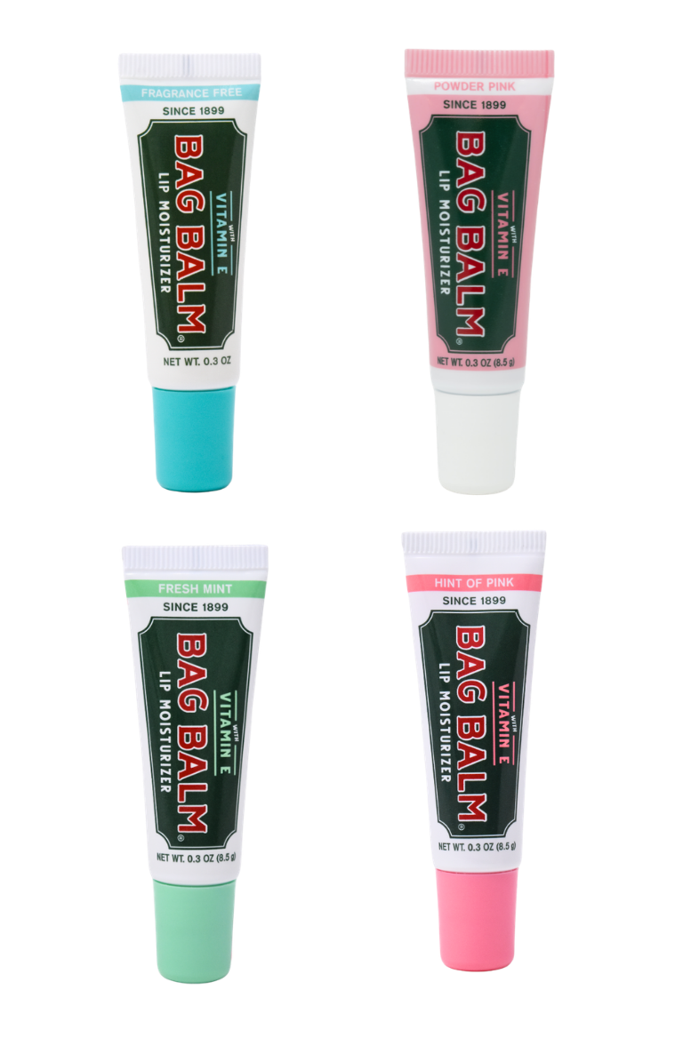 Four tubes of Bag Balm lip balm on a white background