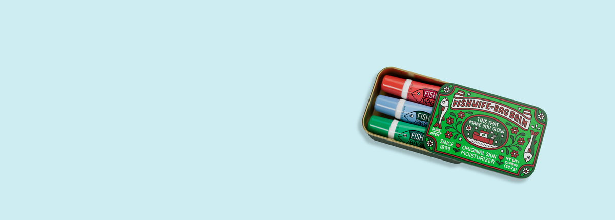 Fishwife x Bag Balm collaboration tin and tubes on blue background