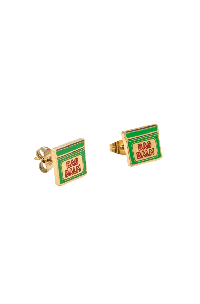 A pair of gold square stud earrings featuring a green and red enamel design that mimics a 'Bag Balm' package, shown on a plain white background.
